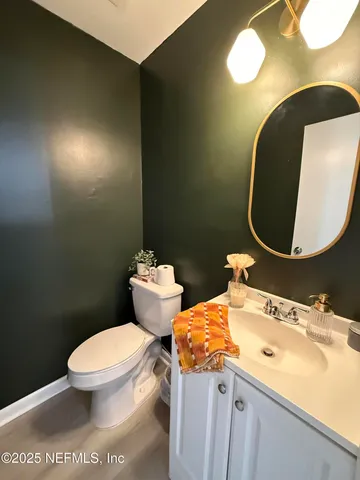 a view of a patio with couches table and chairs and potted plants