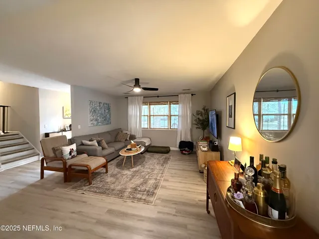 a living room with furniture and a large mirror