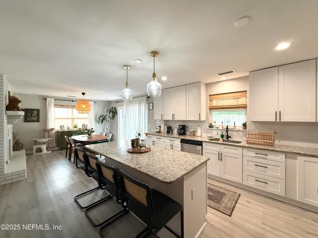 a kitchen with sink stove and cabinets