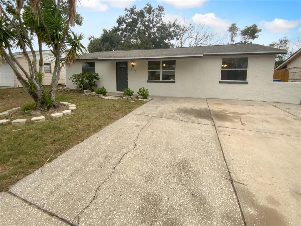 6413 Butte Avenue New Port Richey, FL 34653 - Photo 1 of 1 a backyard of a house with table and chairs