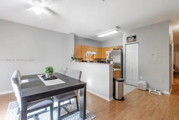 a kitchen with stainless steel appliances a dining table and chairs