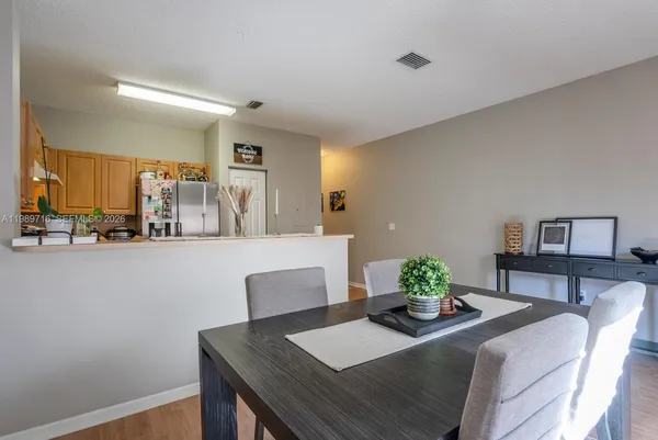a living room with kitchen island furniture and a potted plant