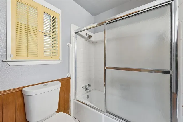 a bathroom with a shower and a toilet