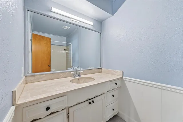a bathroom with a sink and a mirror