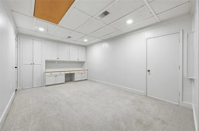 a view of a kitchen with a sink and cabinets