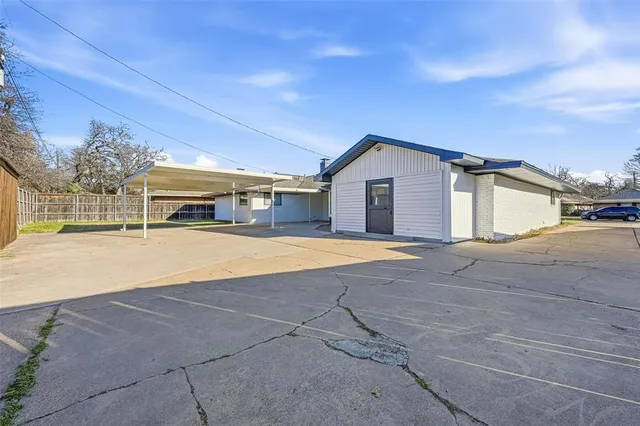 a view of house with yard and trees in the background