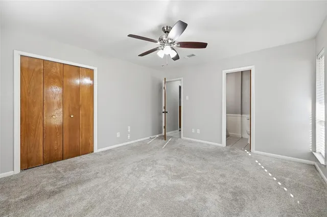 a view of an empty room with a ceiling fan