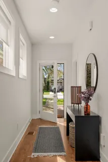 a bedroom with a bed and a dresser next to a window