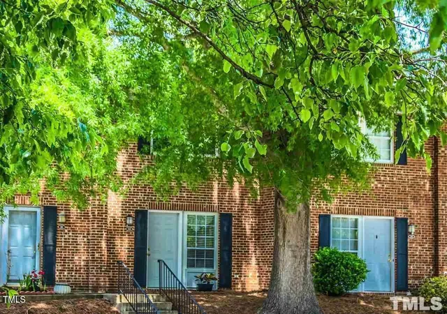 front view of a house with a tree