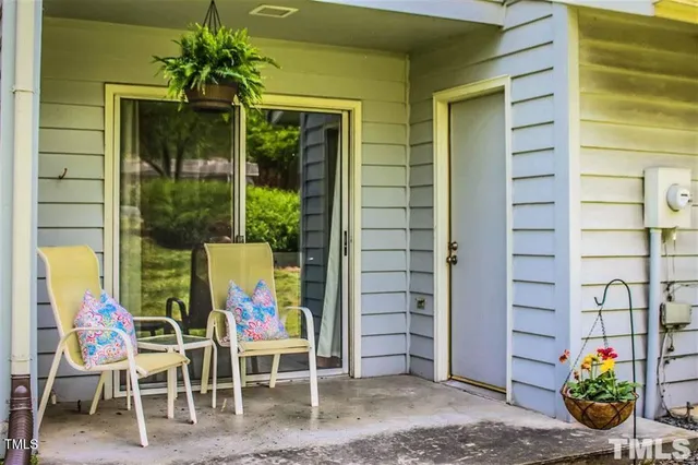 a sign that is sitting in front of a tree