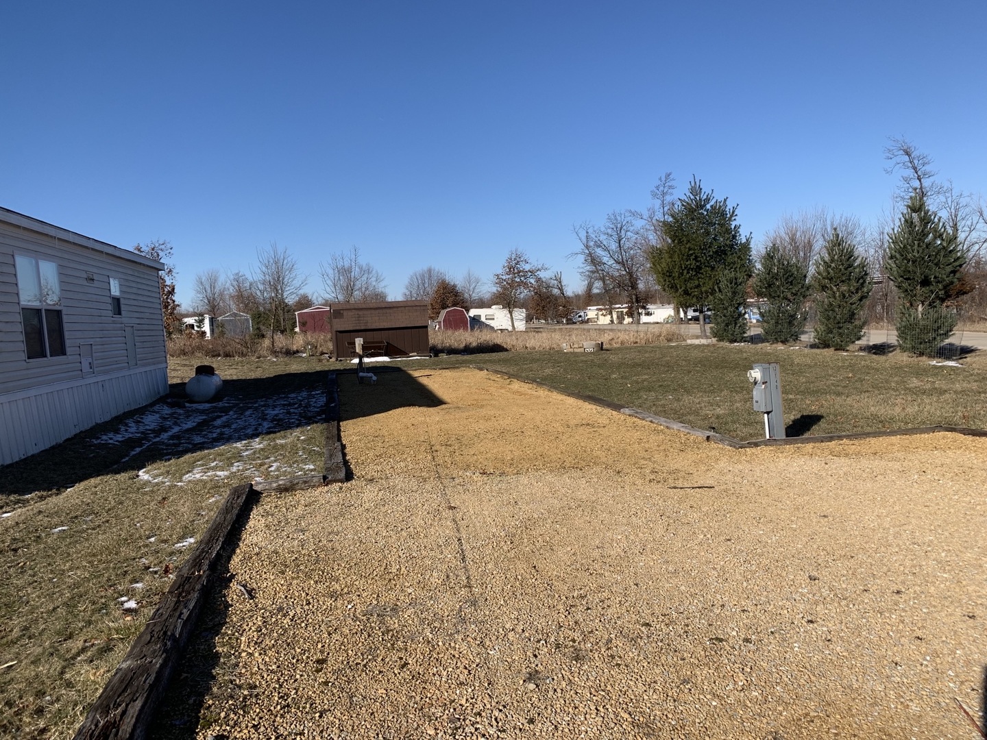 a view of a yard with wooden fence