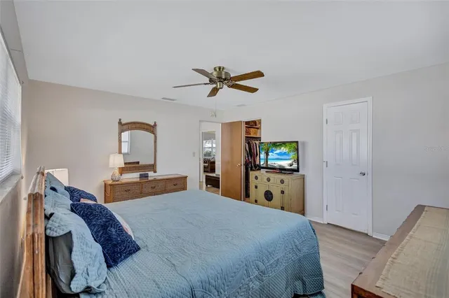 a bed room with a bed and a television