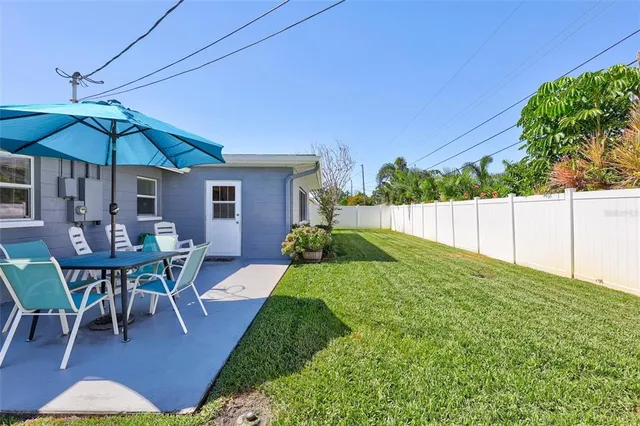 a view of backyard with seating and green space