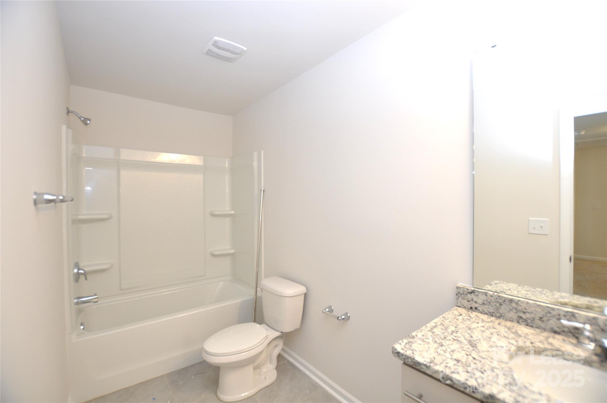 8007 Oakmere Road Waxhaw, NC 28173 - Photo 14 of 28 a bathroom with a granite countertop sink a toilet and shower