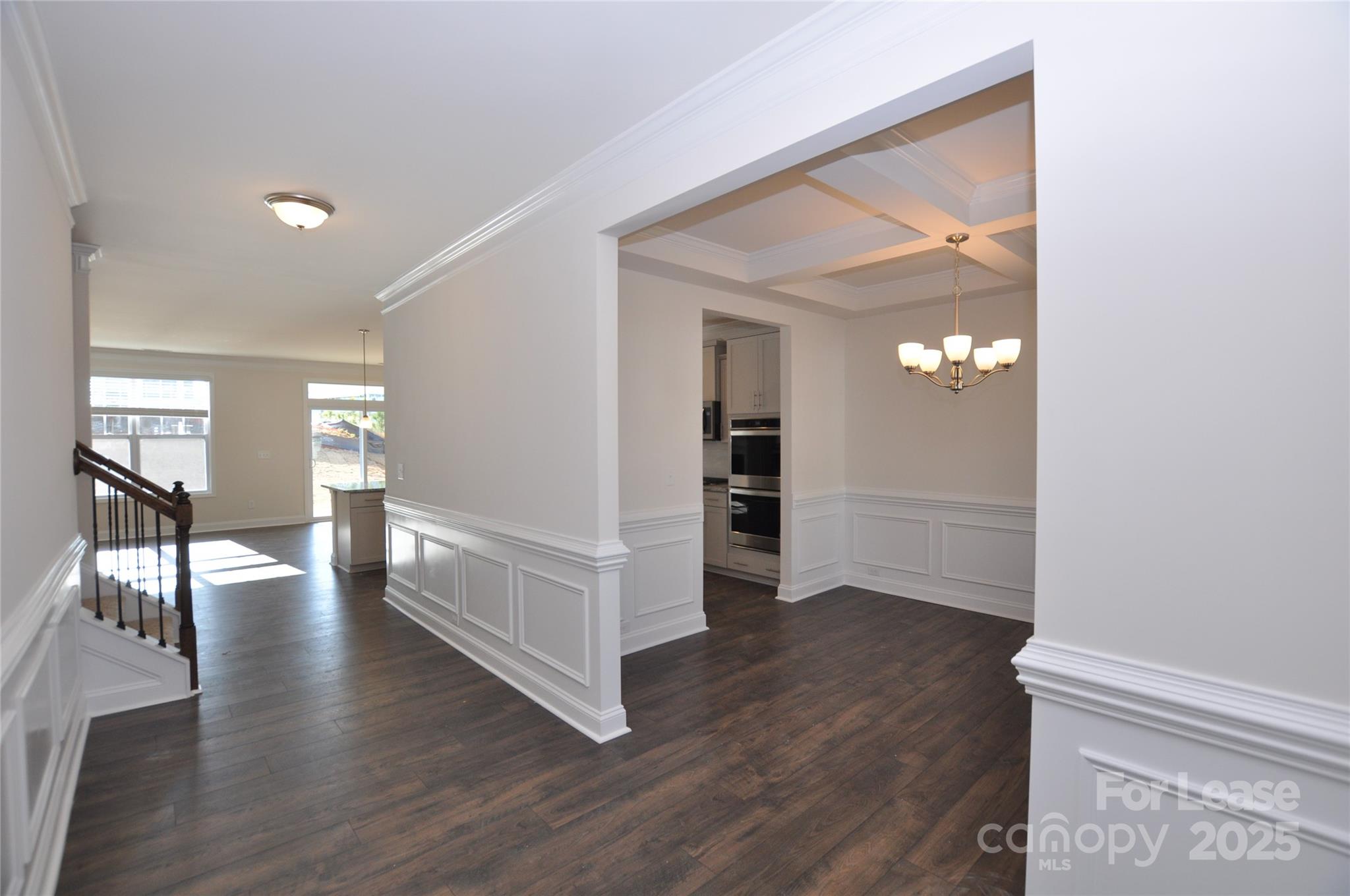 8007 Oakmere Road Waxhaw, NC 28173 - Photo 4 of 28 a view of a hallway with wooden floor windows and a living room