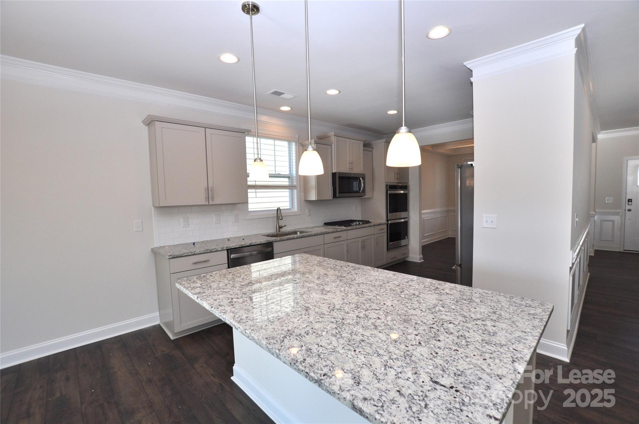 8007 Oakmere Road Waxhaw, NC 28173 - Photo 7 of 28 a kitchen with a refrigerator a sink and wooden floor