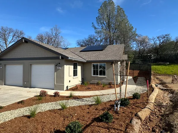 a front view of a house with garden
