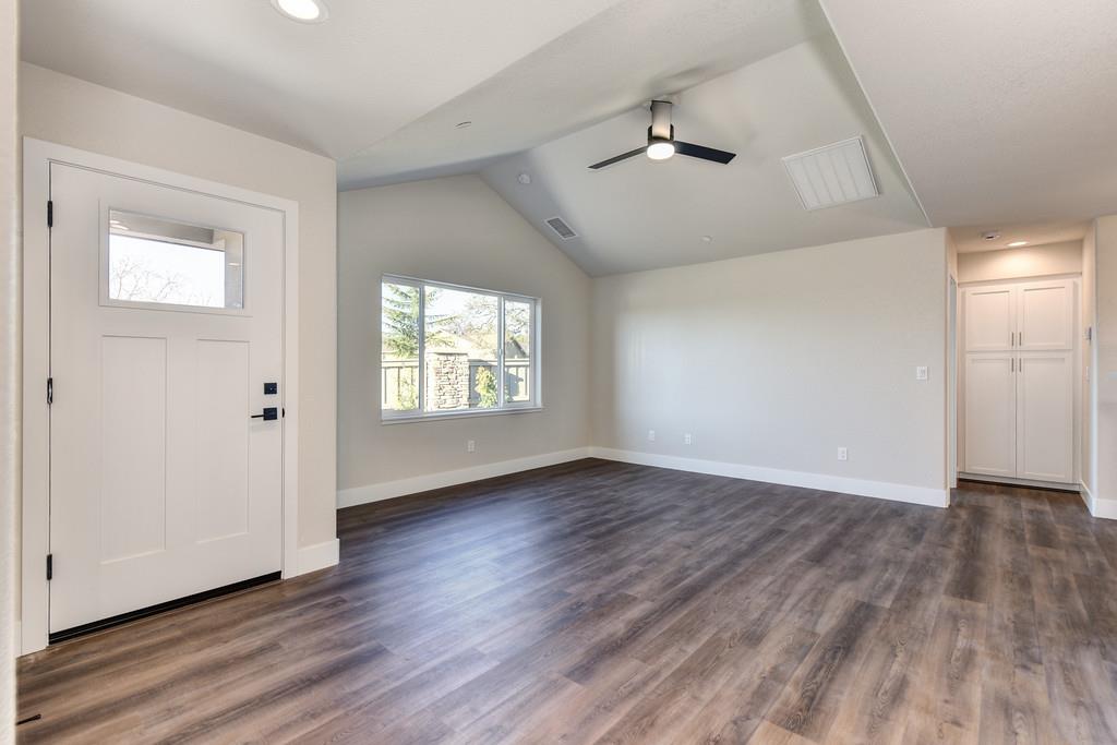 2667 Commons Place Auburn, CA 95603 - Photo 21 of 30 an empty room with wooden floor chandelier and windows