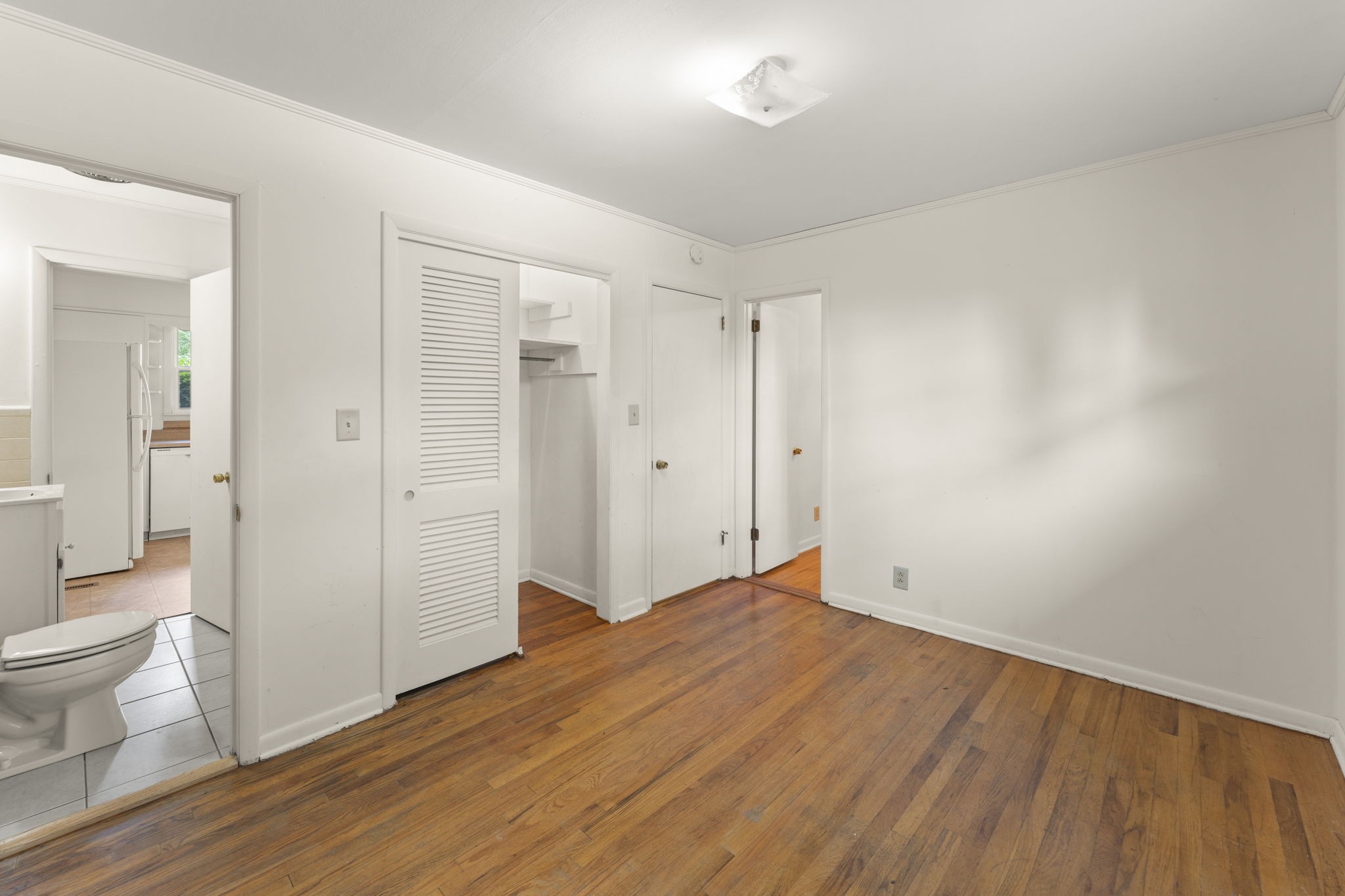 307 Mary Sharp Drive Decherd, TN 37324 - Photo 14 of 27 a big room with wooden floor and bathroom view