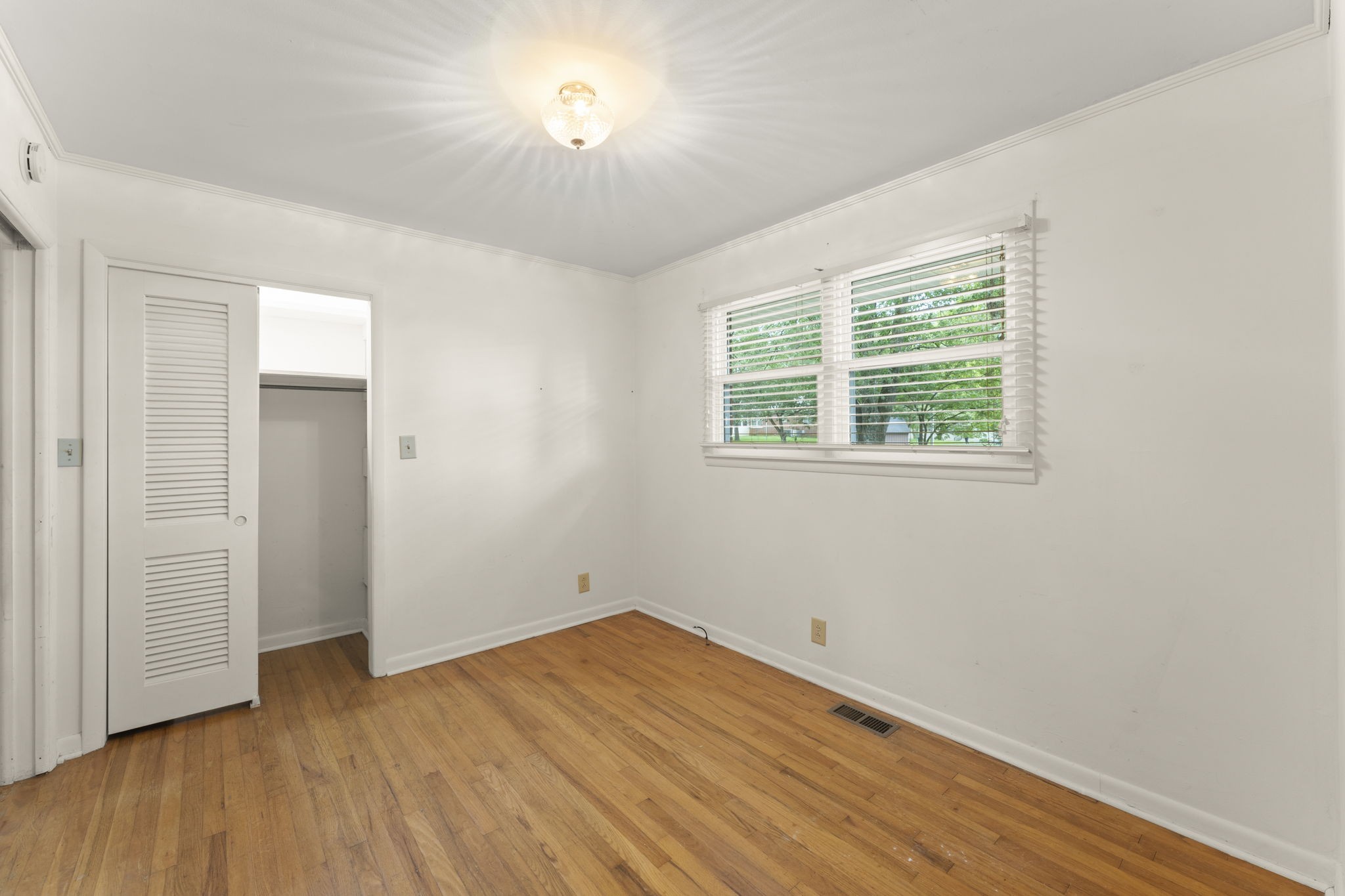307 Mary Sharp Drive Decherd, TN 37324 - Photo 16 of 27 an empty room with wooden floor and windows