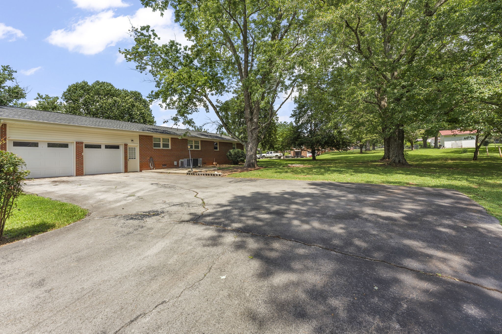 307 Mary Sharp Drive Decherd, TN 37324 - Photo 27 of 27 a view of a house with a big yard and large trees