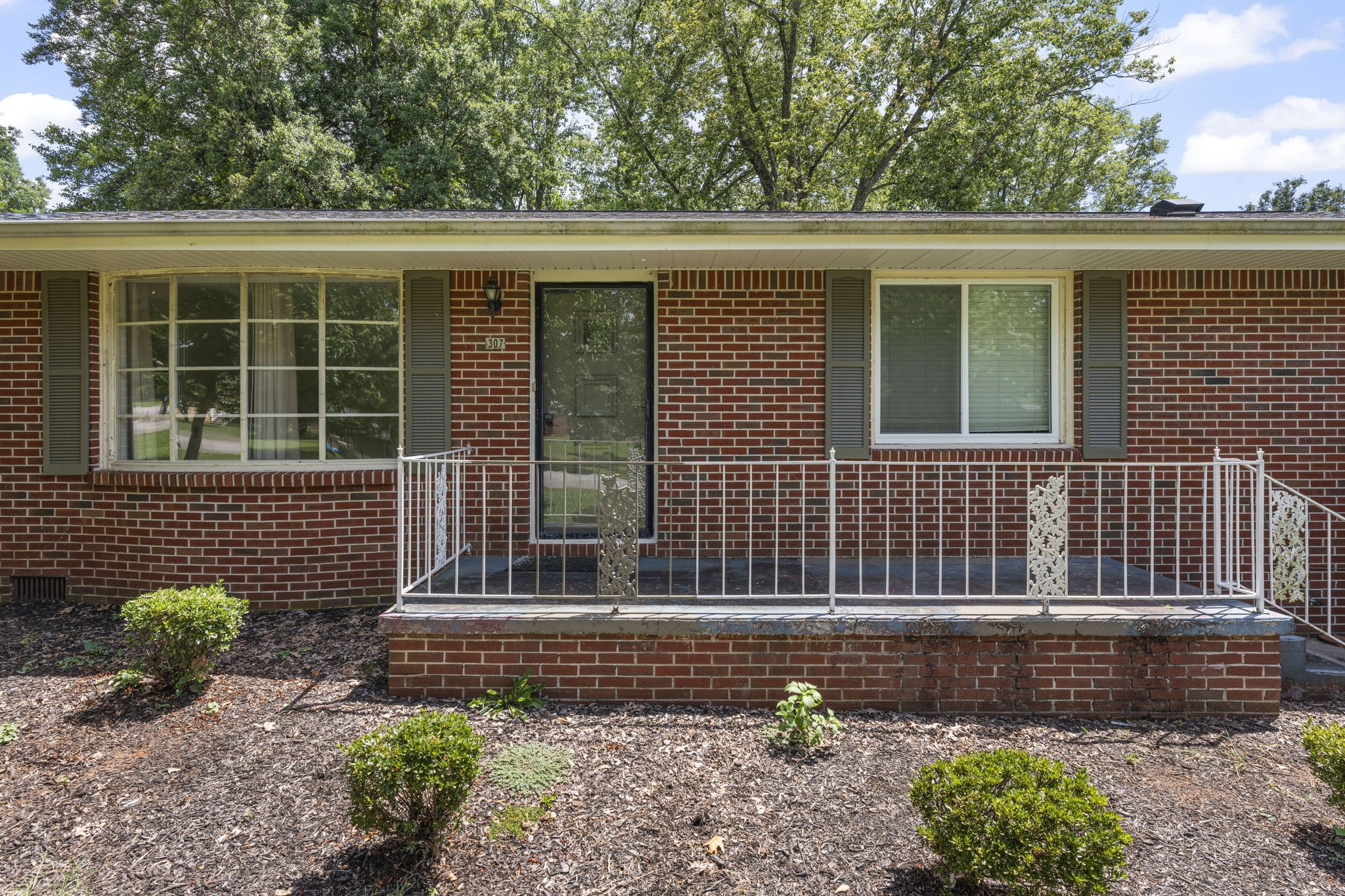307 Mary Sharp Drive Decherd, TN 37324 - Photo 5 of 27 a front view of a house with a garden