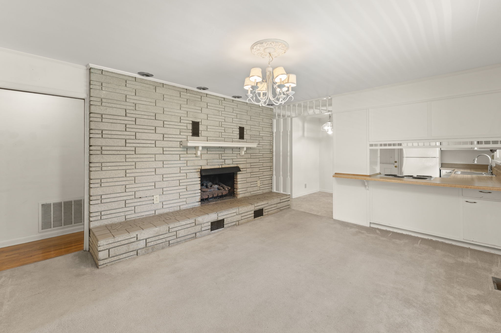 307 Mary Sharp Drive Decherd, TN 37324 - Photo 9 of 27 a view of a livingroom with a fireplace a chandelier and windows