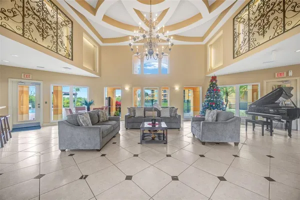 a living room with fireplace furniture and a large window