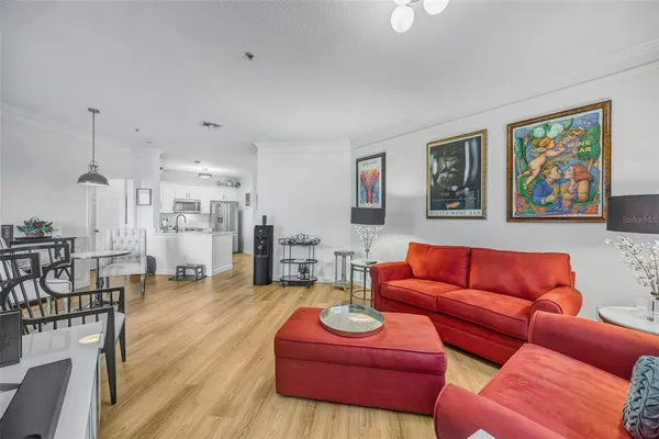 a view of a room with furniture and wooden floor