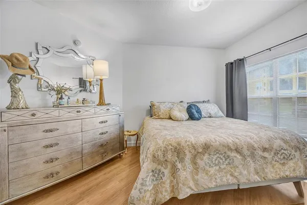 a bedroom with a bed couch and a window