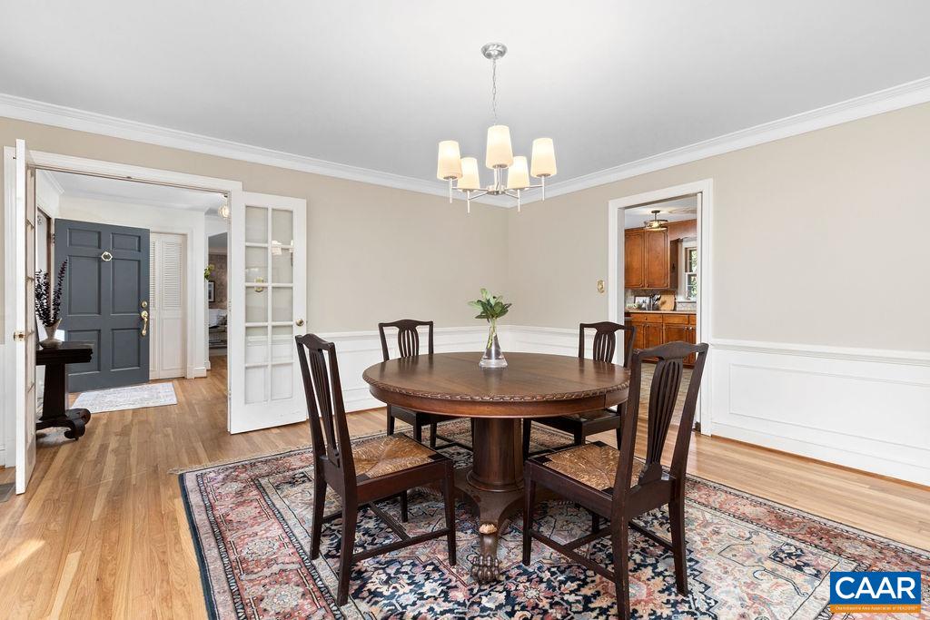 1730 Old Forge Road Charlottesville, VA 22901 - Photo 12 of 48 a view of a dining room with furniture a chandelier and wooden floor