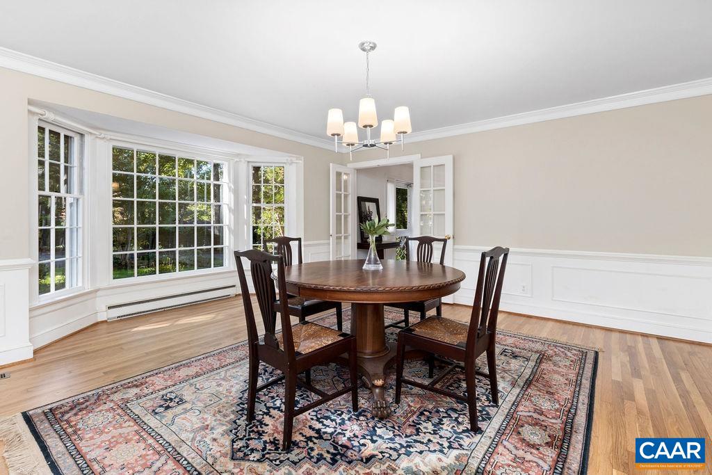 1730 Old Forge Road Charlottesville, VA 22901 - Photo 13 of 48 a view of a dining room with furniture a chandelier and wooden floor