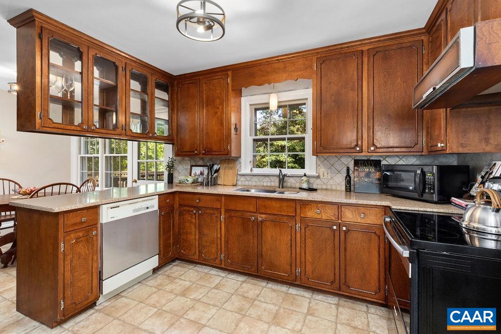 1730 Old Forge Road Charlottesville, VA 22901 - Photo 16 of 48 a kitchen with stainless steel appliances granite countertop a stove sink and cabinets