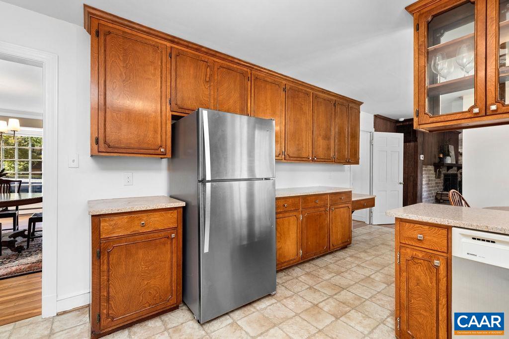 1730 Old Forge Road Charlottesville, VA 22901 - Photo 17 of 48 a kitchen with stainless steel appliances granite countertop a refrigerator a stove and a sink with wooden cabinets