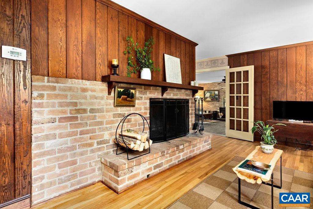 1730 Old Forge Road Charlottesville, VA 22901 - Photo 24 of 48 a living room with furniture a fireplace and a flat screen tv