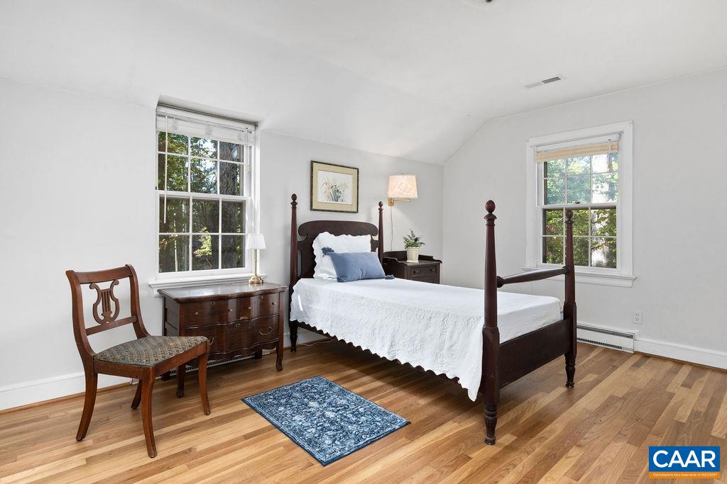 1730 Old Forge Road Charlottesville, VA 22901 - Photo 36 of 48 a bedroom with a bed a table and windows