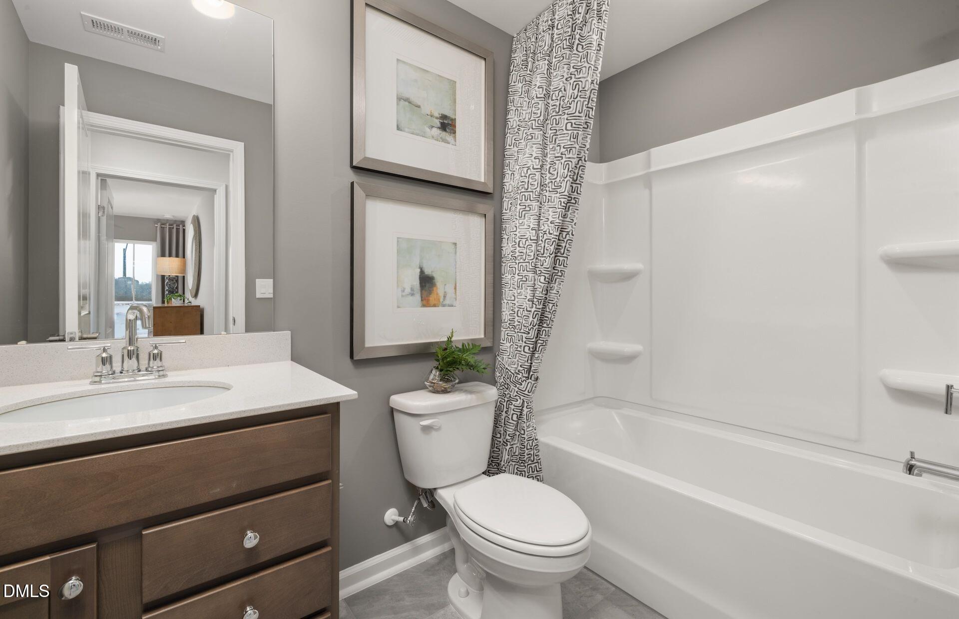 5002 Reader Way Durham, NC 27703 - Photo 16 of 32 a bathroom with a sink a toilet and a bathtub