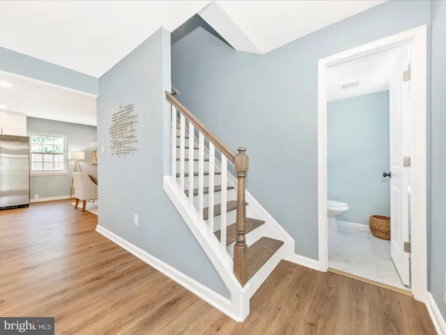 a view of entryway with wooden floor and a living room