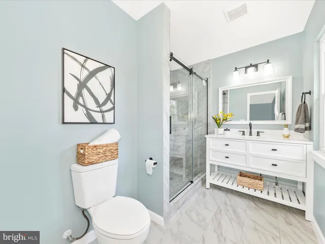 a bathroom with a toilet sink and a mirror