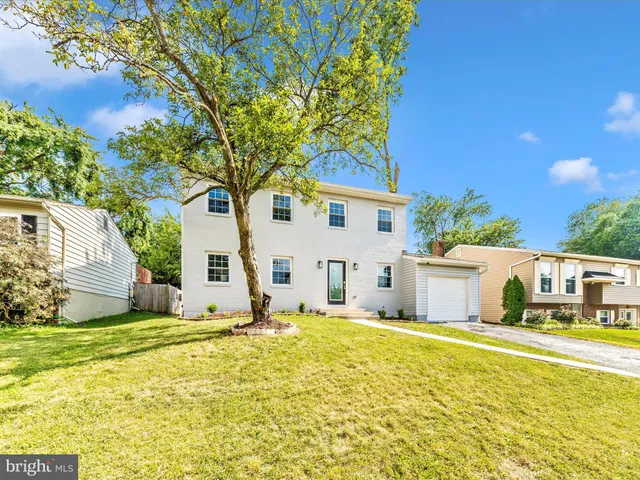 a house that has a tree in front of it