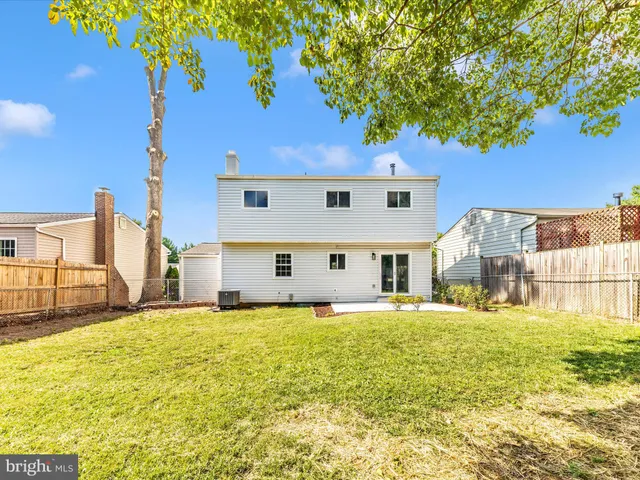 a large house with a large tree and yard