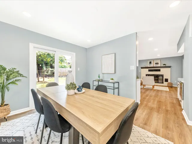 a dining room with a table chairs and kitchen view