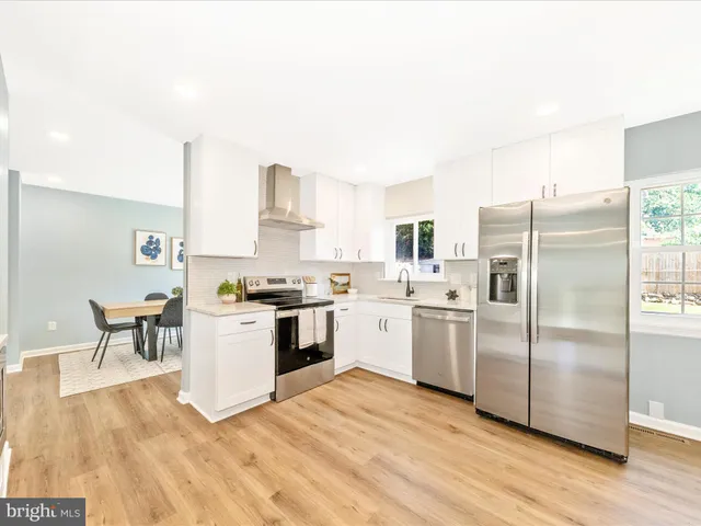 a kitchen with a refrigerator sink and stove