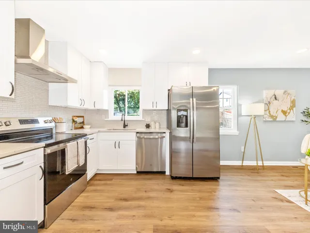 a kitchen with a sink appliances and cabinets