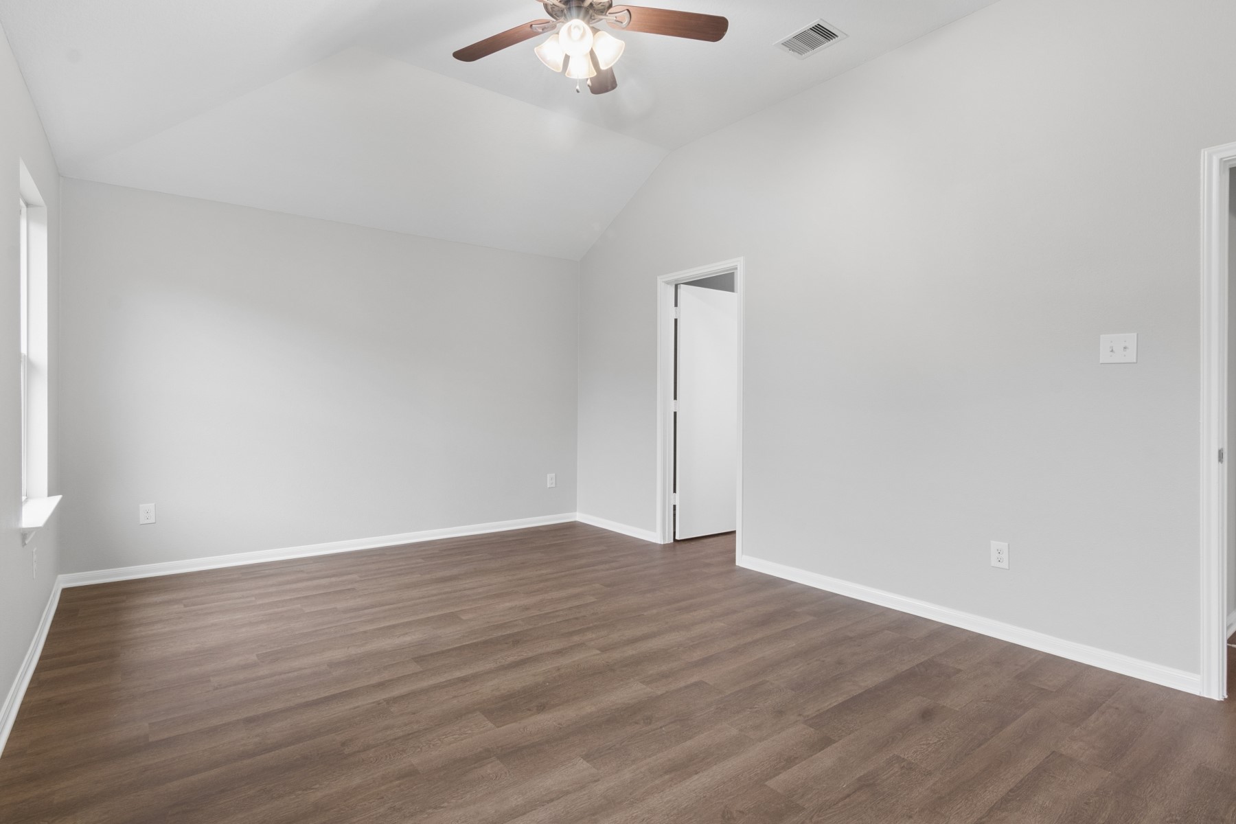 7811 Adonis Avenue Baytown, TX 77521 - Photo 24 of 36 a view of an empty room with wooden floor