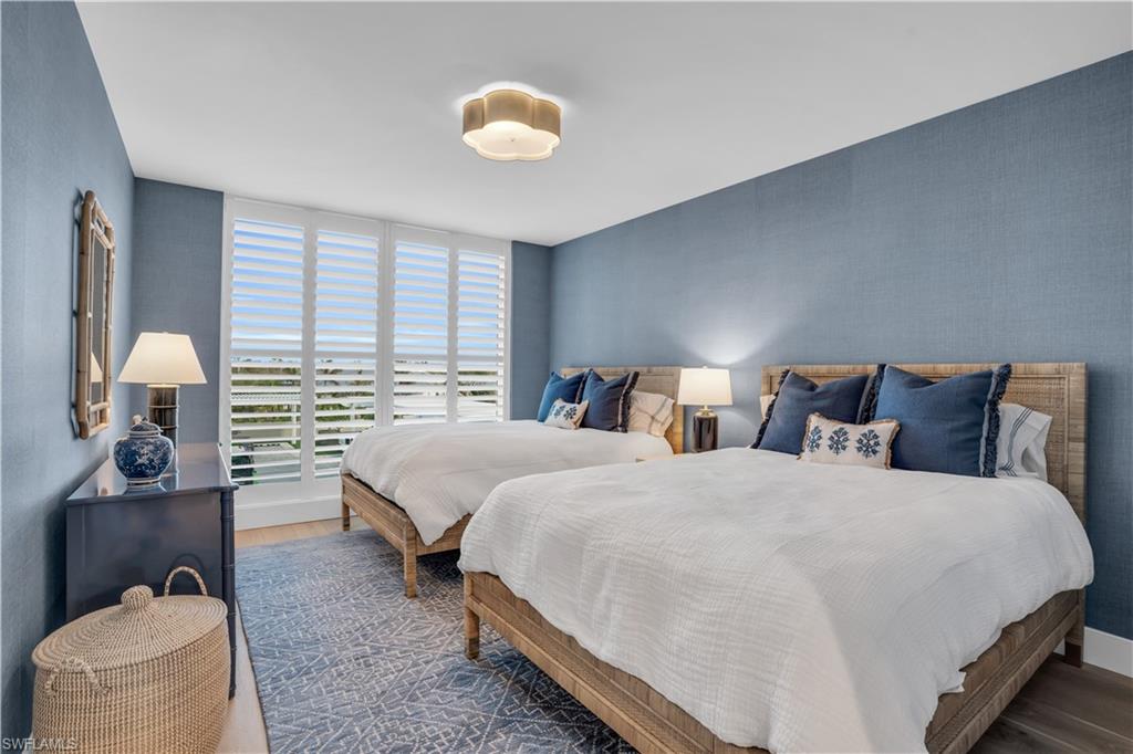 13945 Old Coast Road, Unit 301 Naples, FL 34110 - Photo 19 of 30 a bedroom with two beds and painting on the wall