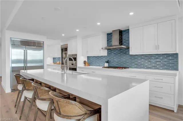 a kitchen with stainless steel appliances granite countertop a sink and cabinets