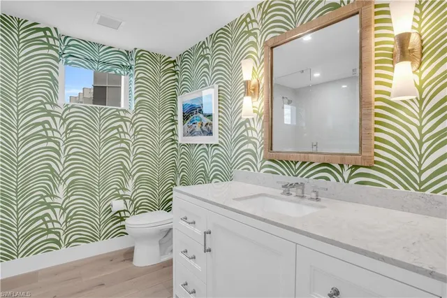 a bathroom with a sink a mirror and a toilet