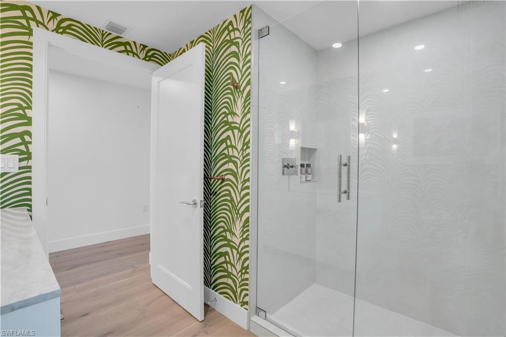 13945 Old Coast Road, Unit 301 Naples, FL 34110 - Photo 25 of 30 a bathroom with a shower and a sink