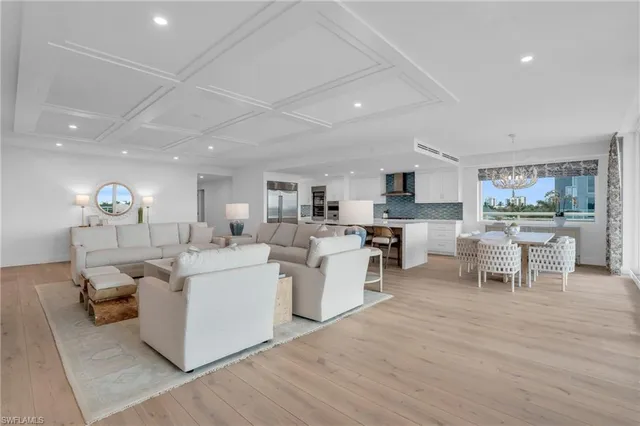 a living room with furniture a dining table and chairs